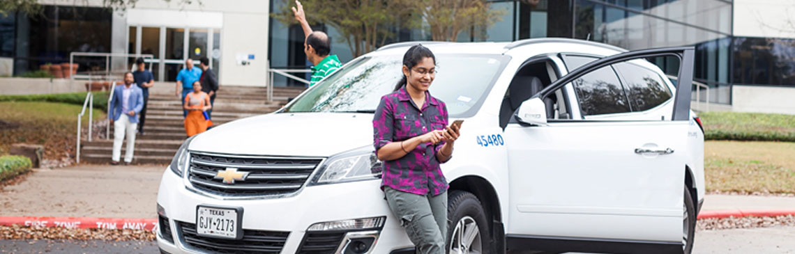 image of coworkers approaching a white van to carpool home