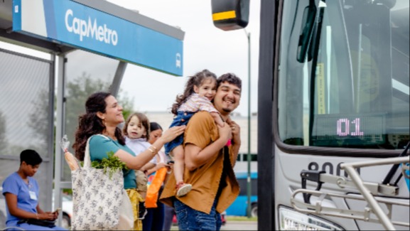 Image of family with their kids boarding a CapMetro bus