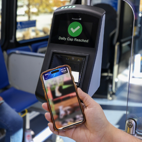 hand tapping digital wallet and seeing daily cap reached message on scanner