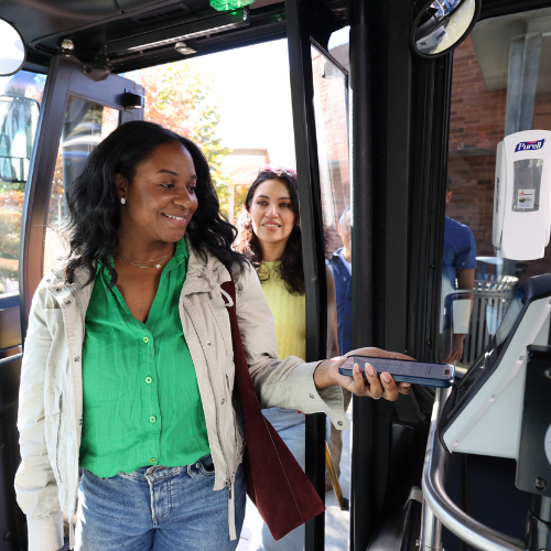 Rider using a mobile device to tap to pay bus fare
