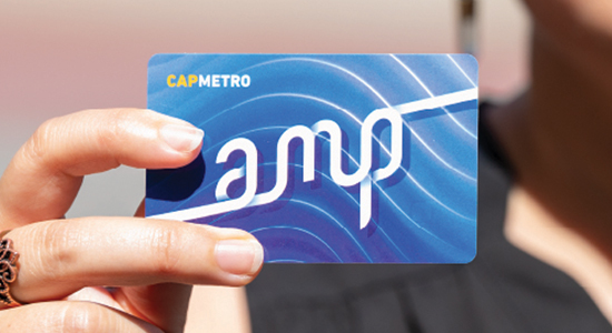 An image of a woman's hand holding an Amp card