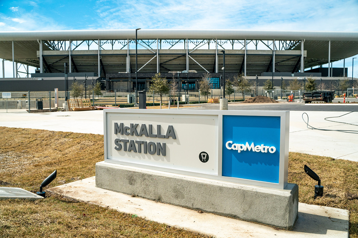 McKalla Station sign with Q2 Stadium in the back ground